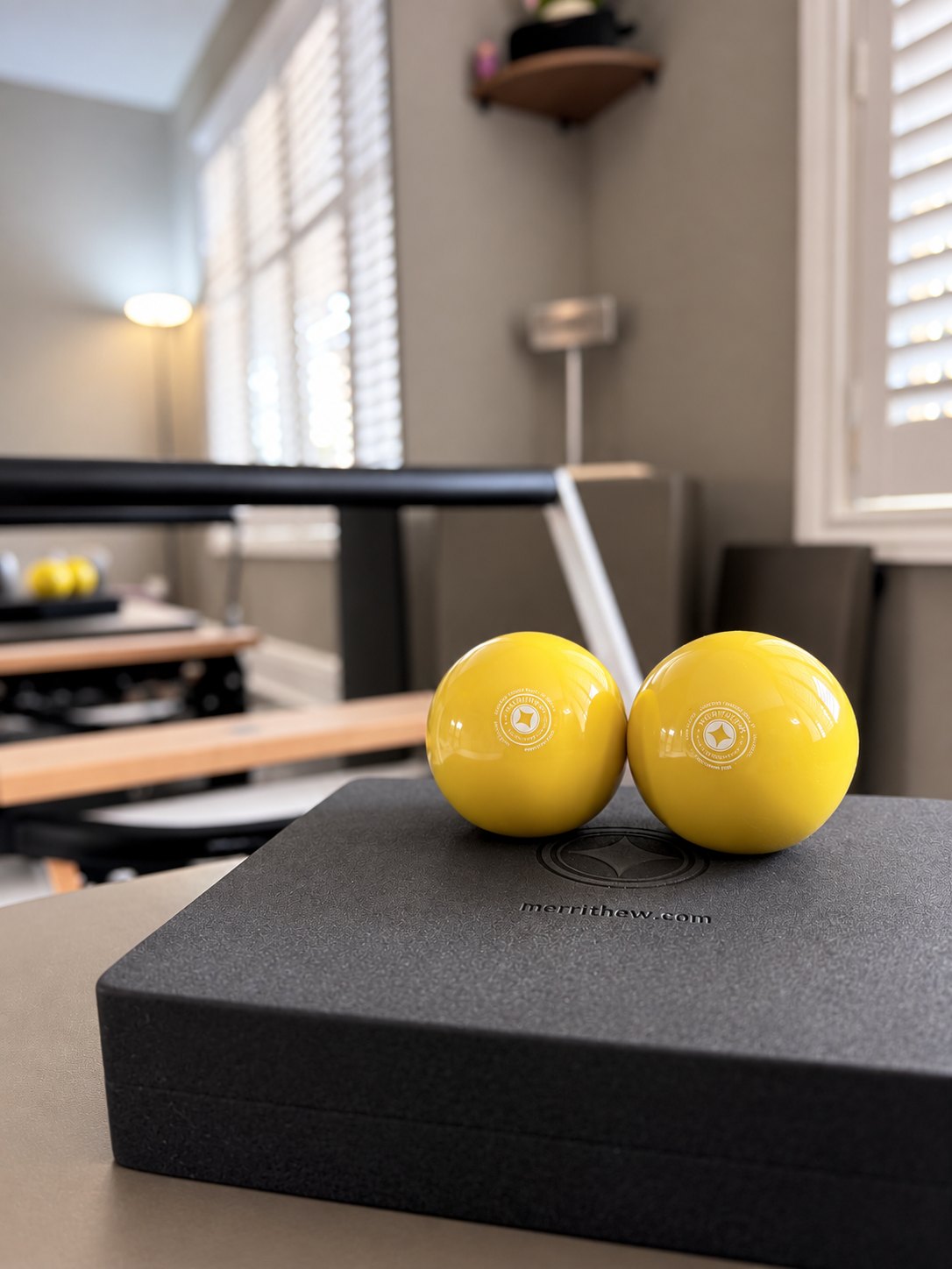 Two Pilates exercise balls on studio equipment